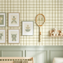 Children's room with plaid wallpaper, framed pictures, and toys.