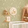 Woodland mushroom wallpaper behind baby crib with deer wall art and soft neutral