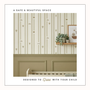 “Wallpaper installed above sage green wall panelling with text reading ‘A safe and beautiful space, designed to grow with your child.’”