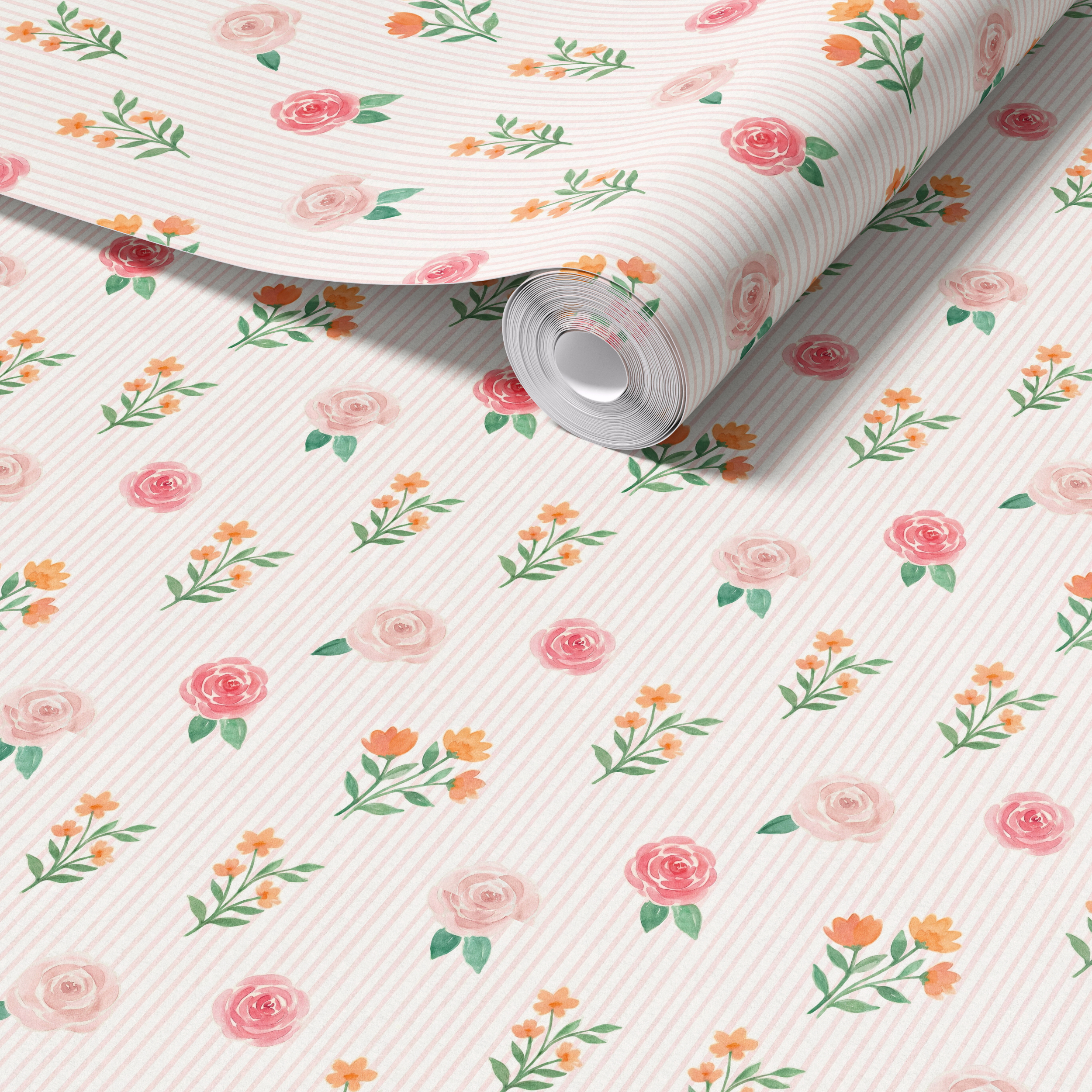 Close up of blush pink floral stripe wallpaper roll showing delicate roses wildflowers and soft vertical stripes