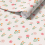 Close up of blush pink floral stripe wallpaper roll showing delicate roses wildflowers and soft vertical stripes