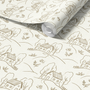 Roll of wallpaper with a pattern of houses and trees on a white background