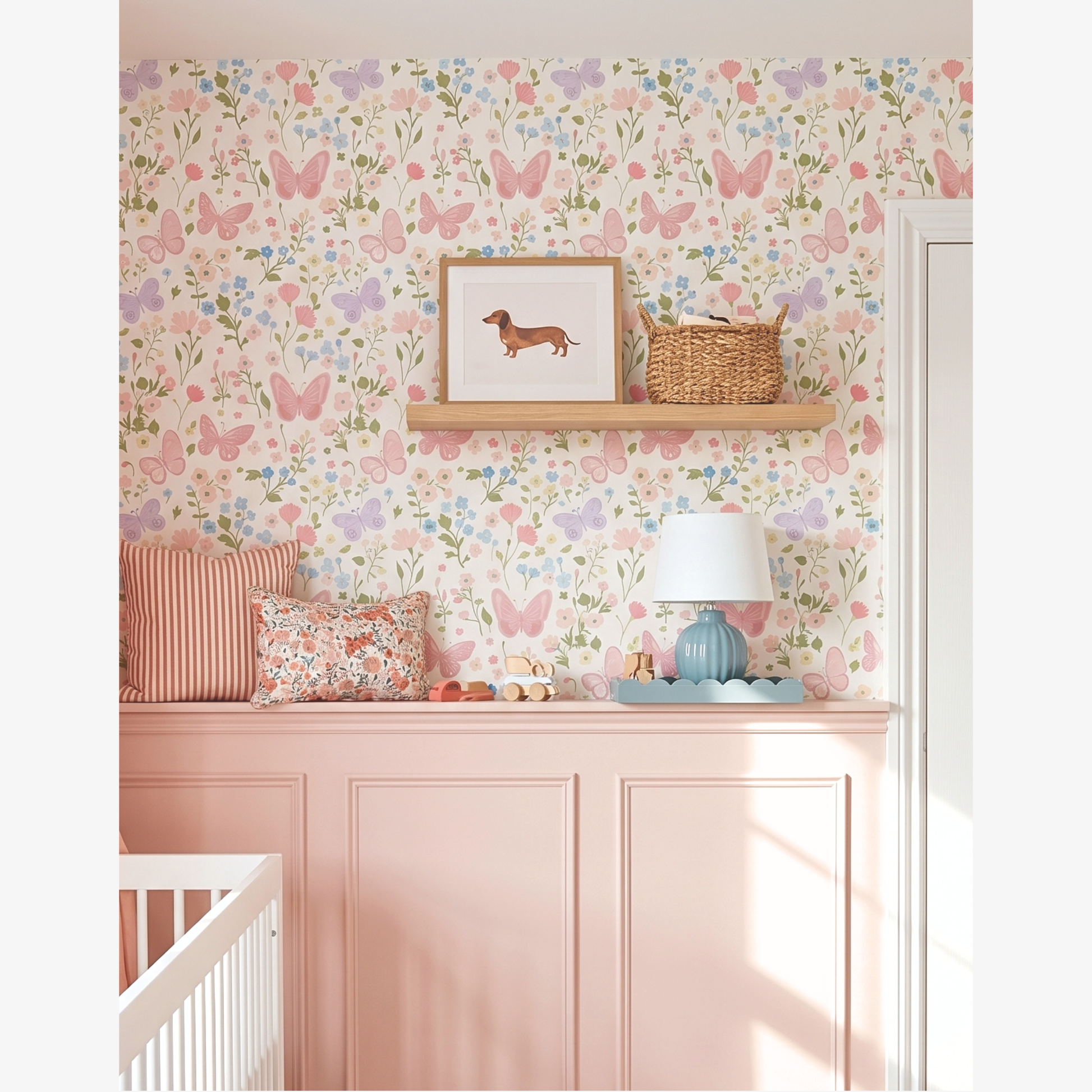 Butterfly floral wallpaper behind nursery shelf styling with cushions, lamp and toys, pastel girls bedroom wall decor