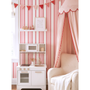 Pink and red striped wallpaper in kids playroom with toy kitchen and armchair, playful nursery wall decor