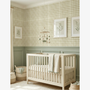 Nursery room with checkered wallpaper, white crib, and decorative elements.