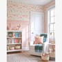 Butterfly floral wallpaper in girls reading corner with armchair, bookshelf and pastel decor, cozy nursery playroom styling