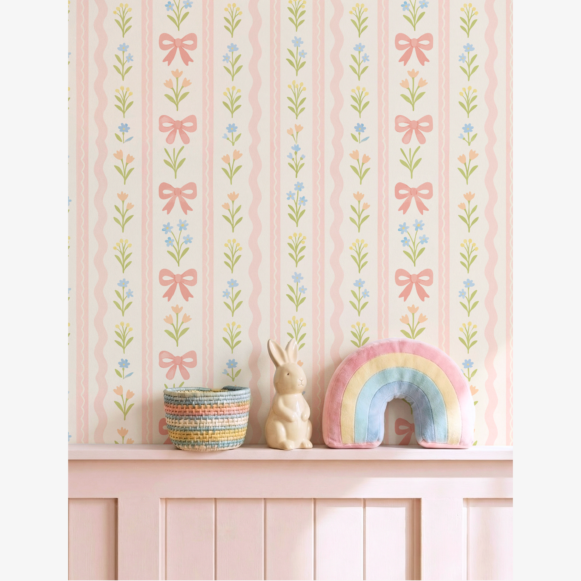Pink striped bow wallpaper with floral pattern in nursery shelf styling, pastel rainbow cushion and bunny decor, soft girl room aesthetic